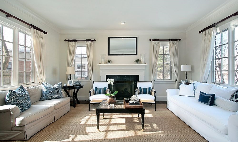 In a large sunroom with sofa and tables