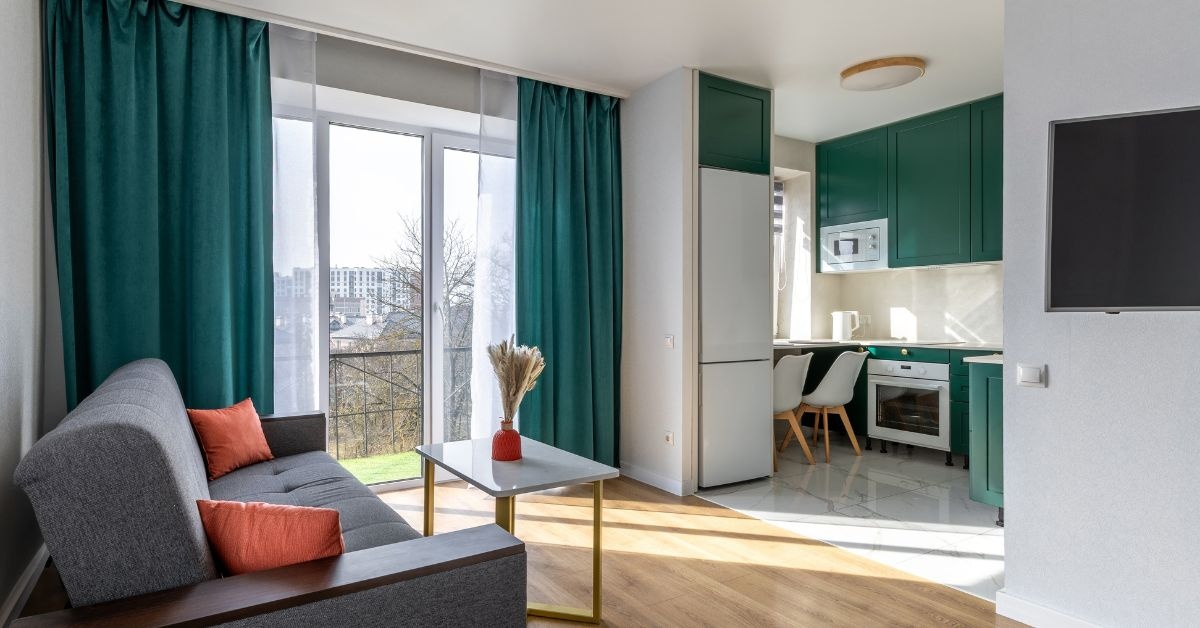 By the window, wooden living Room table with 6 chairs around